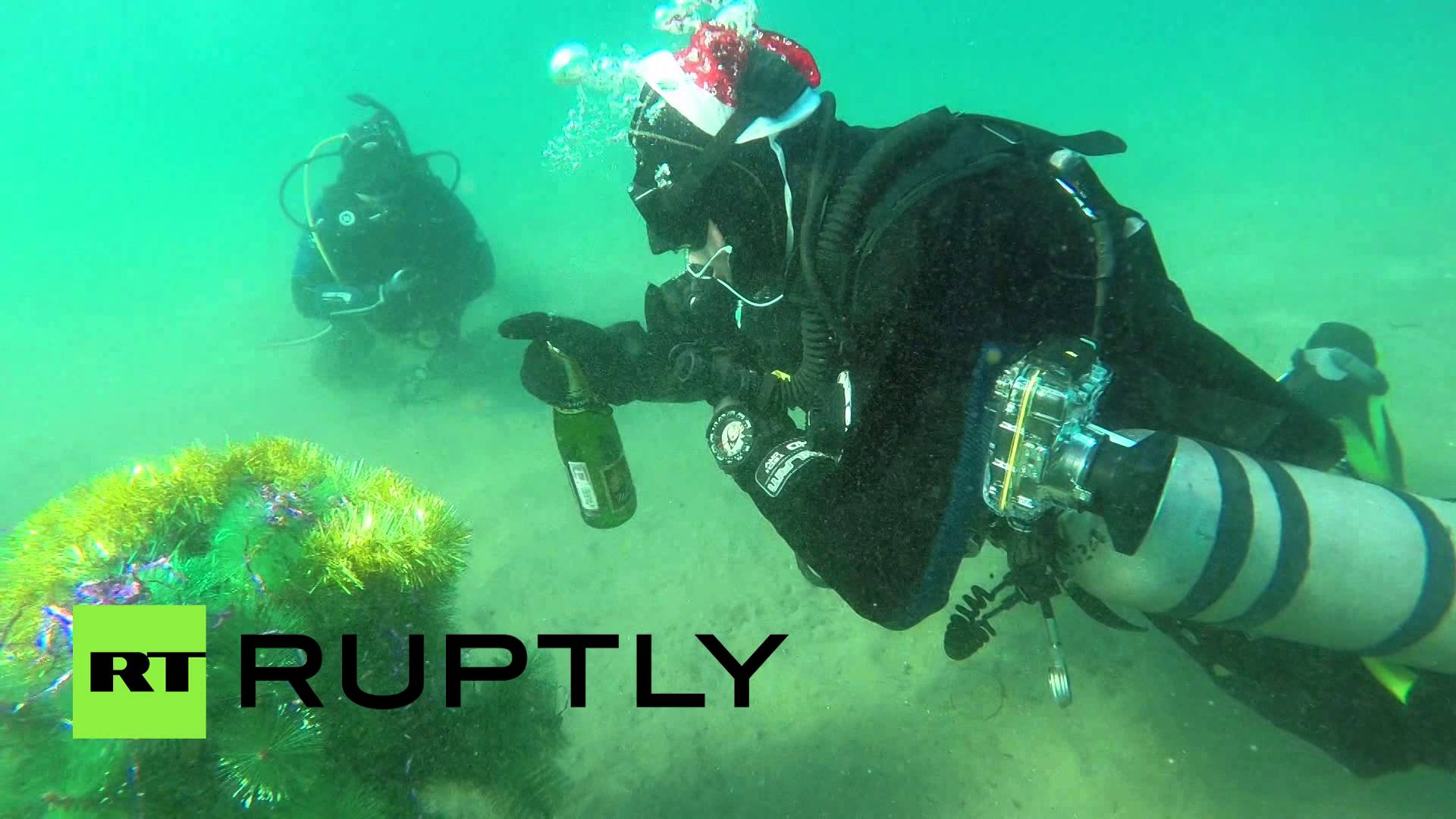 Russian divers drink champagne, dance around New Year tree underwater