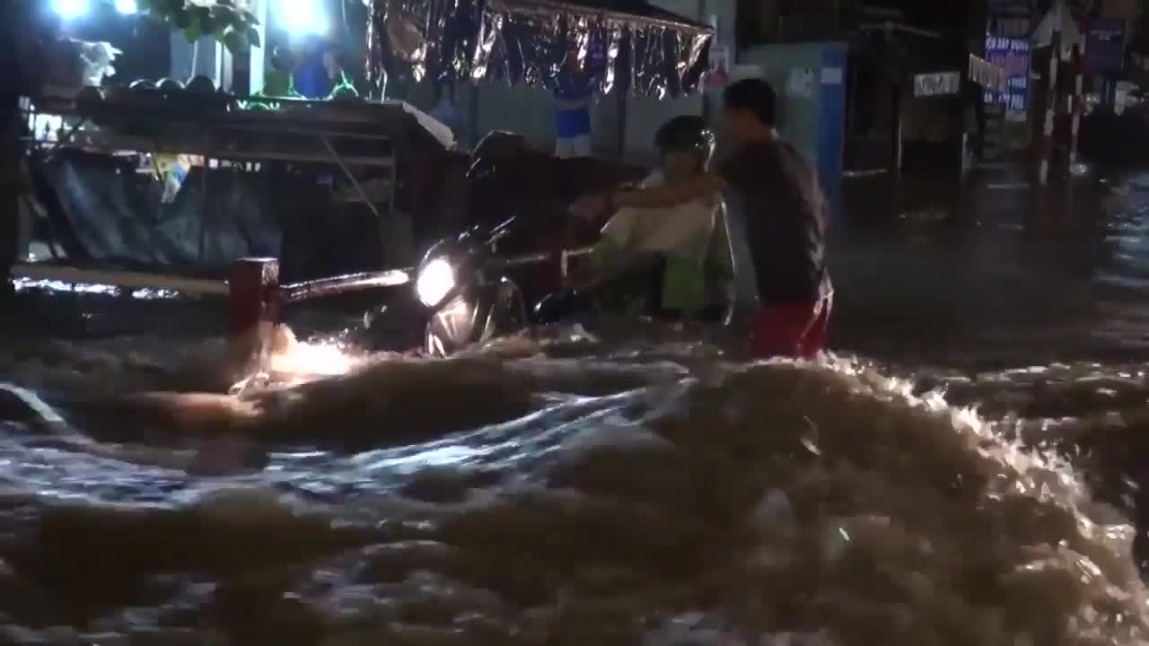 Hàng loạt xe máy bị sóng đánh ngã trên đường ngập ở Đồng Nai